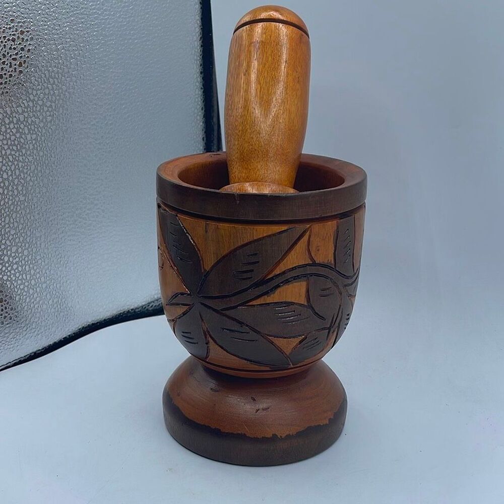 This hand-carved wooden mortar & pestle set carved.